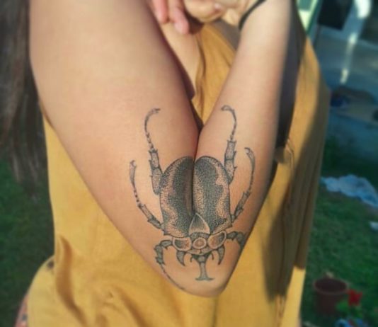 Awesome Beetle Tattoo That Spreads its Wings Alongside Owner’s Arm